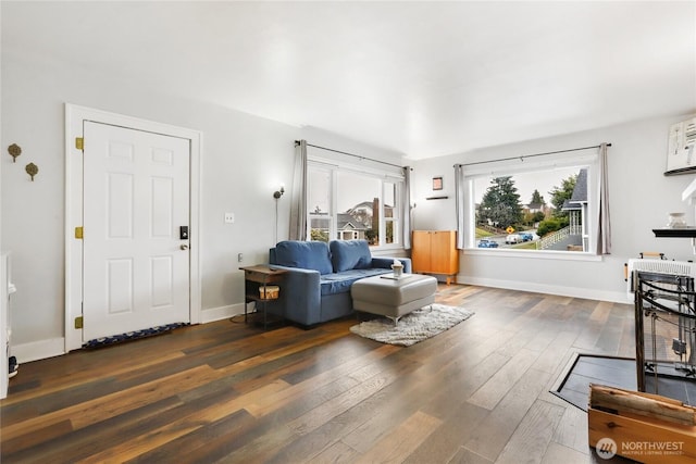 living area featuring hardwood / wood-style flooring and baseboards