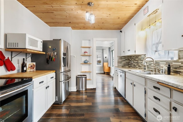 kitchen with appliances with stainless steel finishes, backsplash, a sink, and wood ceiling