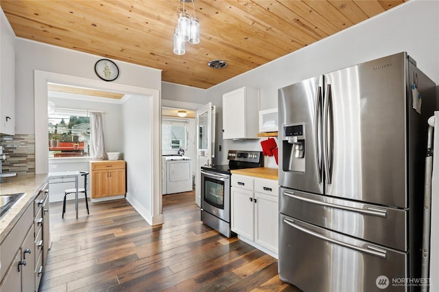 kitchen with wood ceiling, light countertops, appliances with stainless steel finishes, decorative backsplash, and washer / dryer