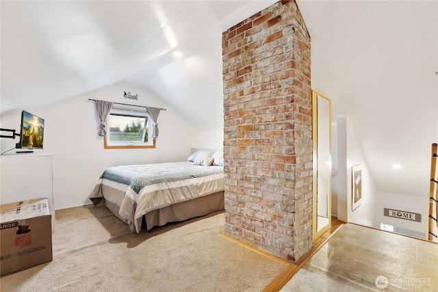 carpeted bedroom with lofted ceiling