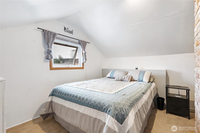 bedroom with lofted ceiling and carpet flooring