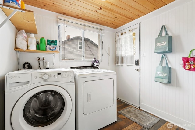 laundry area featuring laundry area, wooden ceiling, washing machine and dryer, and dark wood finished floors