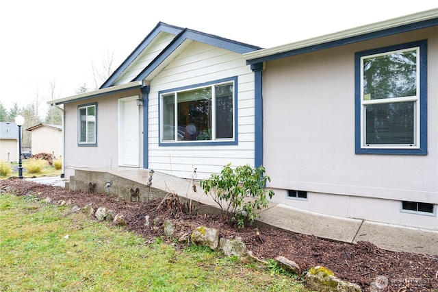 view of side of home featuring crawl space