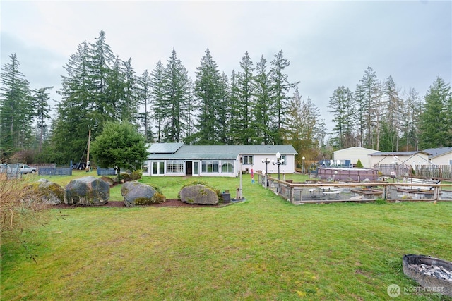 back of property featuring roof mounted solar panels, a garden, and a yard