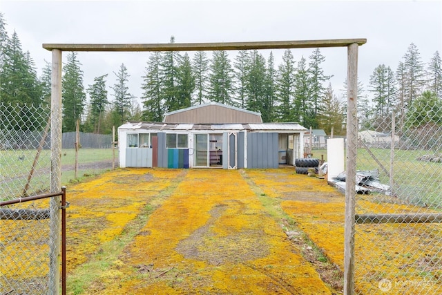 exterior space featuring an outbuilding and fence