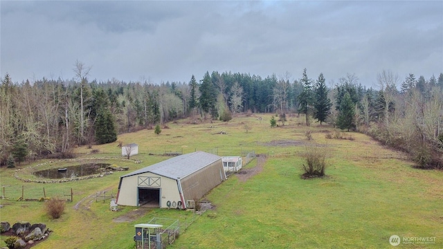 bird's eye view featuring a rural view and a wooded view