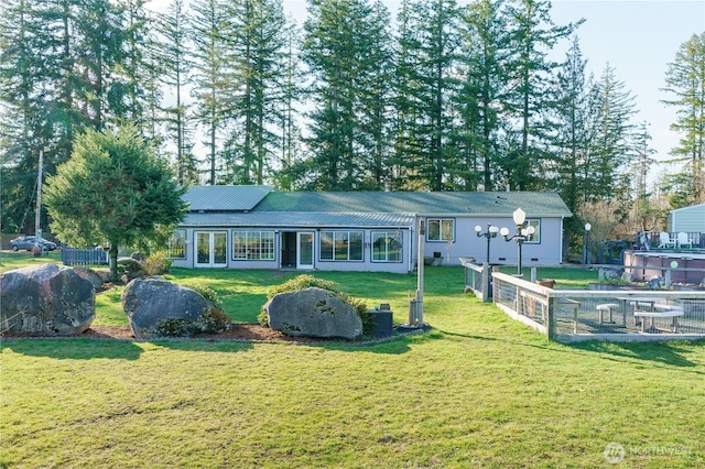 single story home with fence, metal roof, and a front yard