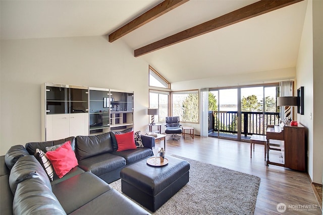 living area featuring high vaulted ceiling, beam ceiling, and wood finished floors