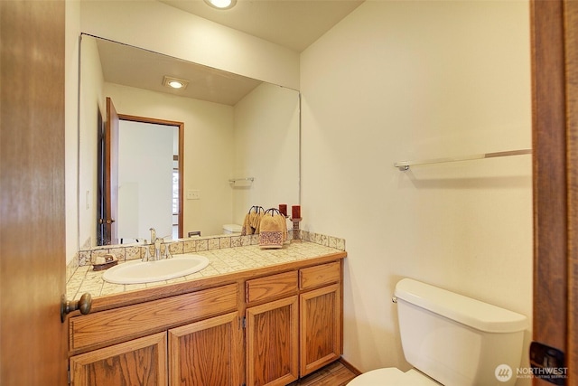 half bathroom featuring toilet and vanity