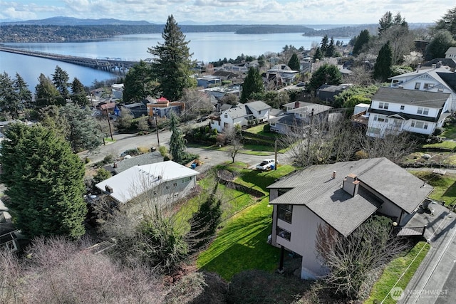 birds eye view of property with a water view and a residential view