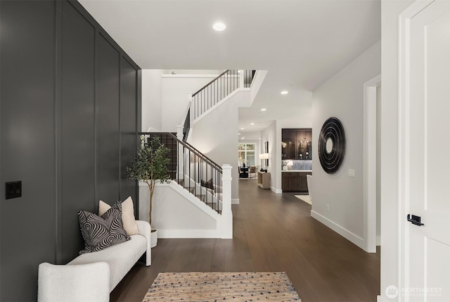 foyer featuring stairs, baseboards, wood finished floors, and recessed lighting