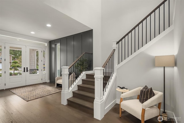 foyer entrance featuring baseboards, wood finished floors, stairs, french doors, and recessed lighting