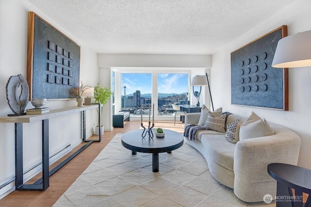 living area with a textured ceiling, a city view, and wood finished floors