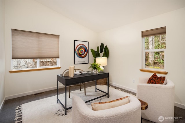 office area with lofted ceiling, visible vents, and baseboards