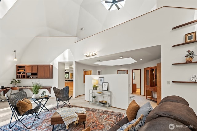 living room with a towering ceiling and ceiling fan