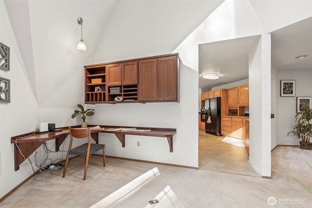 office area featuring high vaulted ceiling, light colored carpet, and baseboards