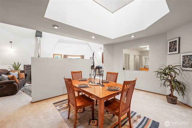 dining room with carpet, a skylight, baseboards, and recessed lighting