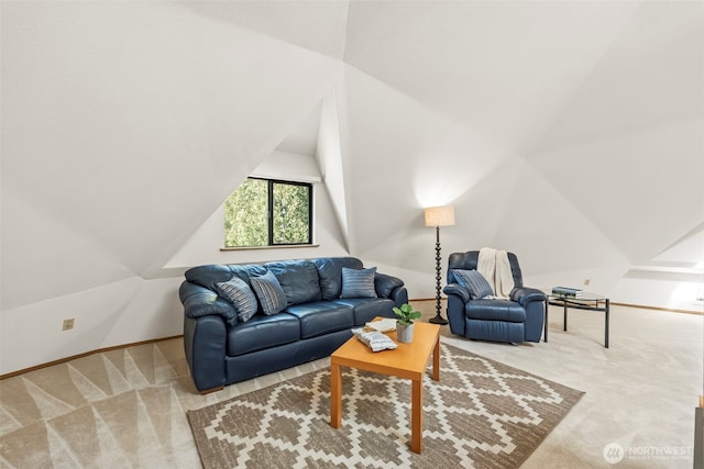 living area with lofted ceiling, carpet floors, and baseboards