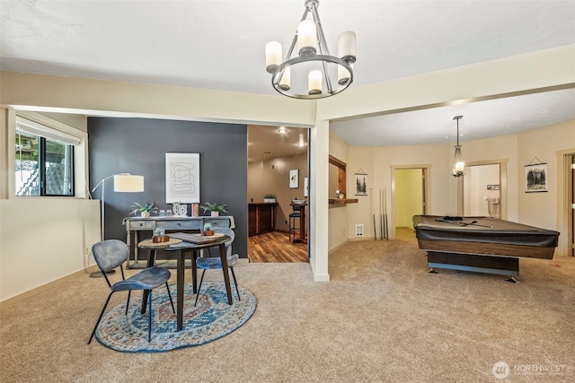 dining space with an inviting chandelier and carpet flooring