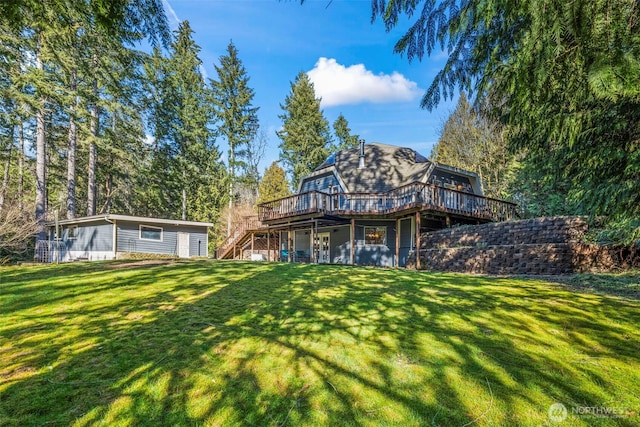 rear view of house featuring a yard, stairway, and a wooden deck