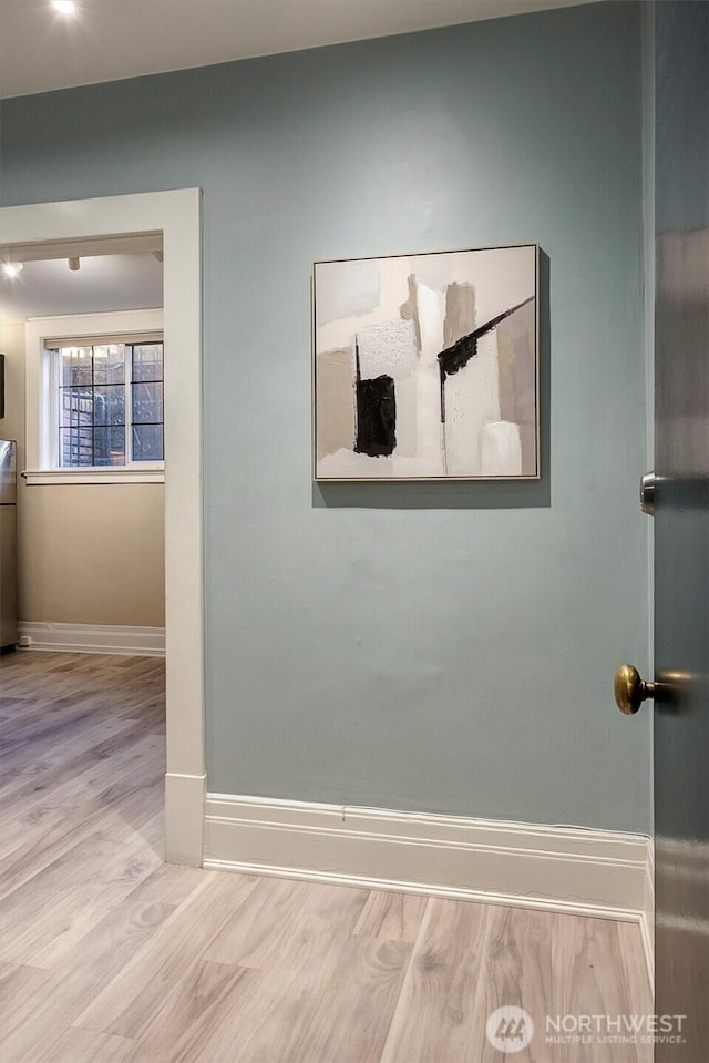 interior details featuring wood finished floors and baseboards