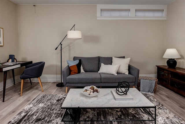 living room featuring baseboards and wood finished floors