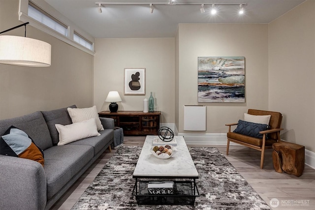 living room featuring wood finished floors and baseboards