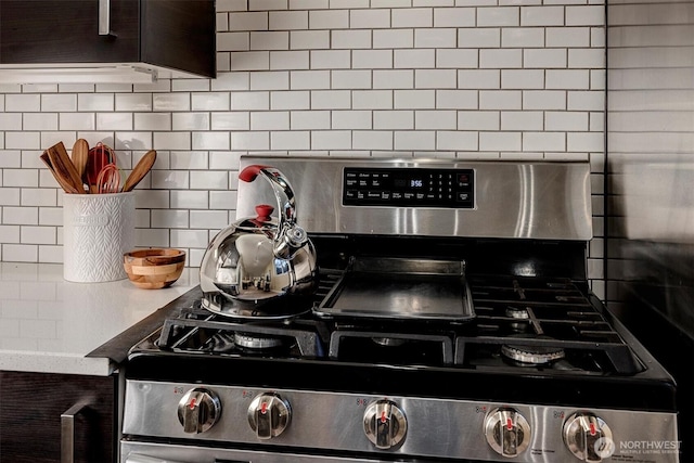 room details with backsplash and stainless steel range with gas stovetop