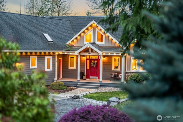 view of front of house with a porch, board and batten siding, and roof with shingles