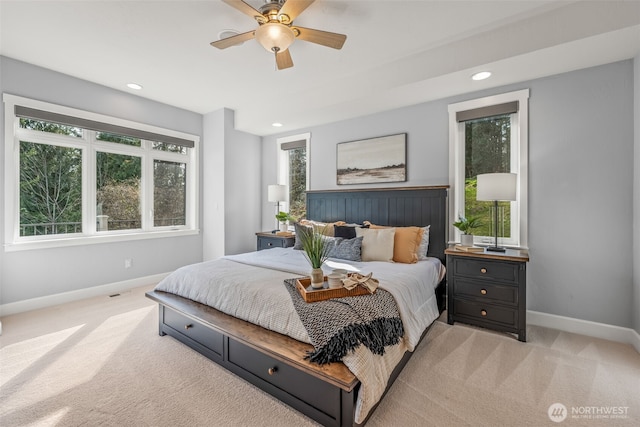 bedroom with recessed lighting, baseboards, and light carpet