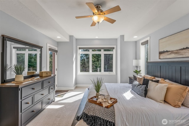 carpeted bedroom featuring a ceiling fan, multiple windows, recessed lighting, and baseboards