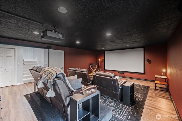 home theater featuring recessed lighting, a textured ceiling, and wood finished floors