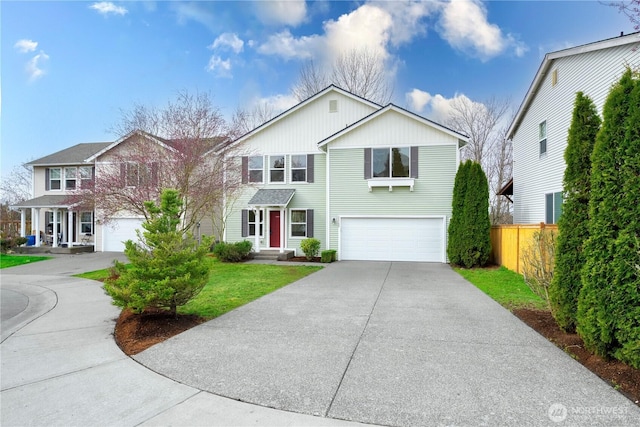 view of front facade featuring concrete driveway, an attached garage, and fence