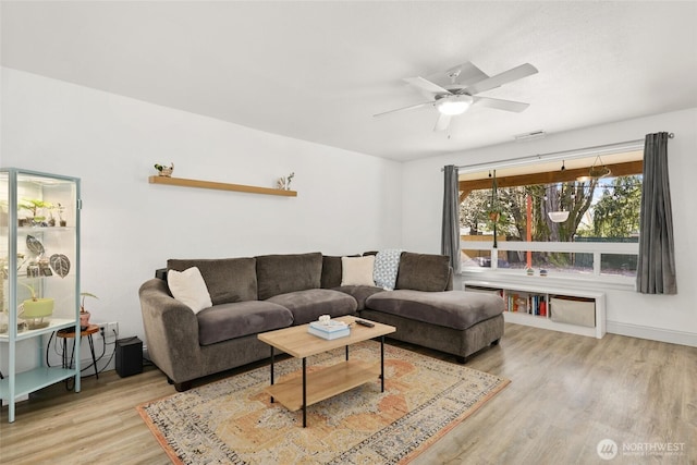 living room with a ceiling fan and wood finished floors