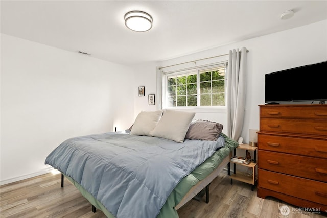 bedroom featuring light wood-type flooring and visible vents