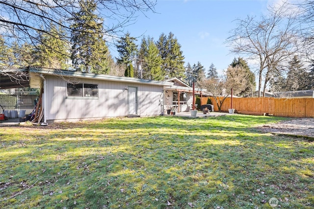 exterior space featuring a patio area, a yard, and fence