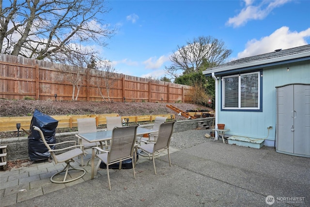 view of patio featuring outdoor dining space and fence