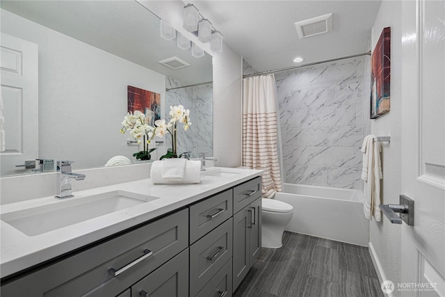 full bath with toilet, shower / tub combo, visible vents, and a sink