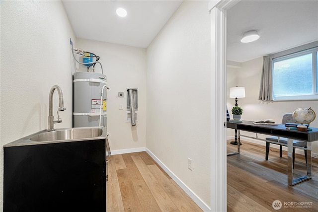 utility room with secured water heater and a sink