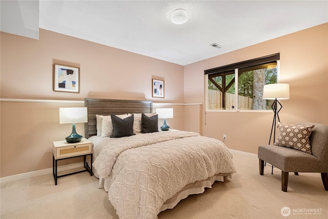 bedroom featuring baseboards, visible vents, and light colored carpet