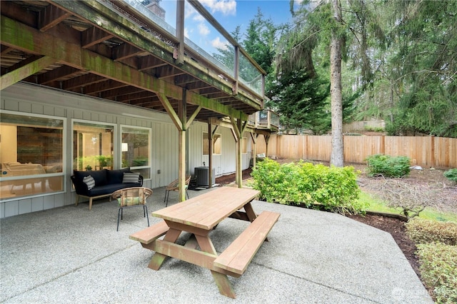 view of patio with outdoor dining area and fence