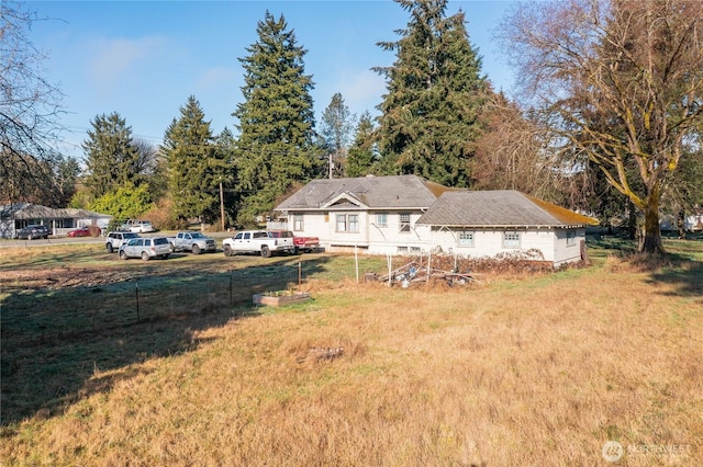 exterior space featuring fence and a front lawn