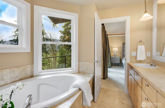 full bathroom featuring tile patterned floors, vanity, ensuite bathroom, and a garden tub