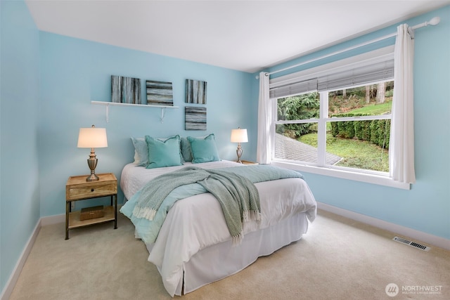 bedroom featuring visible vents, baseboards, and carpet floors