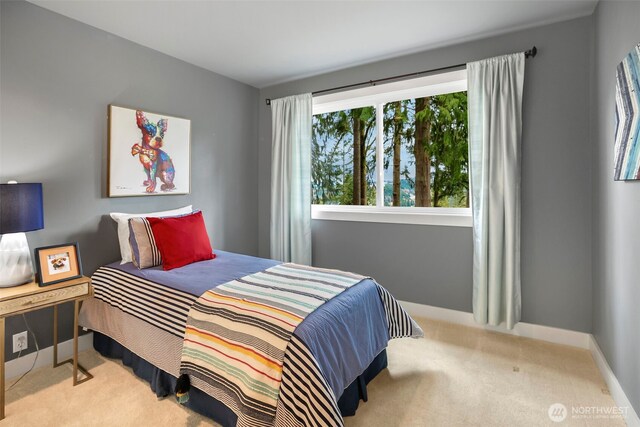 bedroom with carpet flooring and baseboards