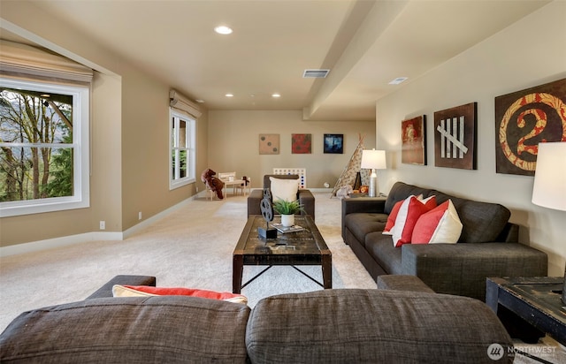 carpeted living area with recessed lighting, visible vents, and baseboards