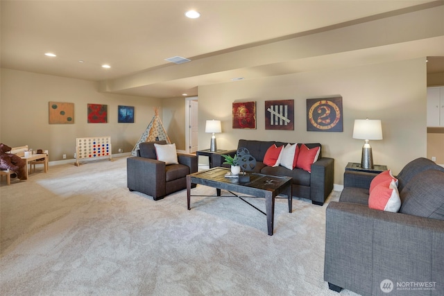 living area with recessed lighting, visible vents, baseboards, and light colored carpet