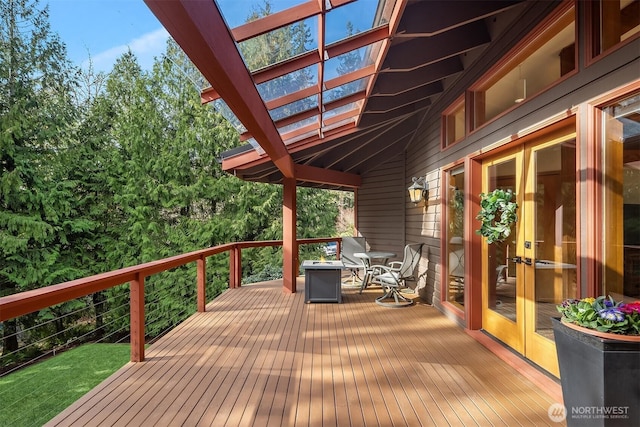 deck featuring french doors and a pergola