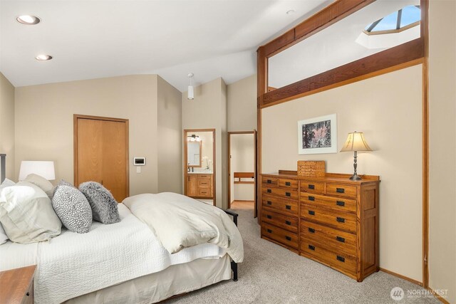 carpeted bedroom featuring recessed lighting, baseboards, lofted ceiling, and ensuite bath