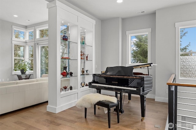 sitting room featuring baseboards, wood finished floors, visible vents, and recessed lighting